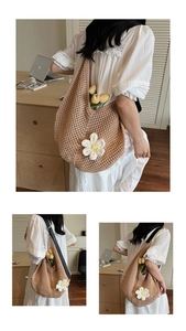 Detail of hand-woven shoulder bag showing white sunflower knit and soft texture