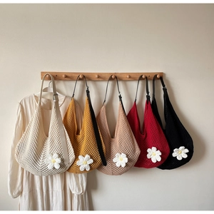 Detail showing five color options of hollow knit hobo bags with white daisy flower appliques