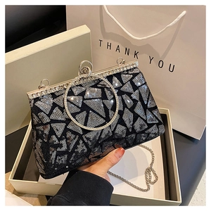 Dettaglio della pochette da sera con paillettes nere, manico ad anello con diamanti e catena