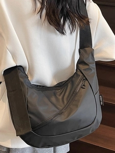 Casual black nylon dumpling crossbody bag with adjustable wide strap for women