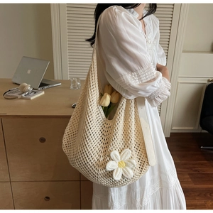 Detail of beige knit mesh shoulder bag featuring 3D daisy flower and faux leather strap