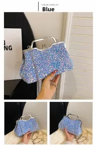 Detail of blue sequin handbag with silver metal frame and elegant chain strap