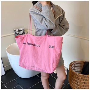 Detailed close-up of a large pink canvas tote bag featuring San Francisco text print