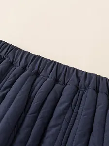 Elastic waistband detail of kids navy blue quilted thermal pants with vertical stitching