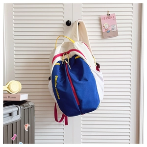 Detail of multi-color canvas backpack with red zippers and breathable shoulder straps