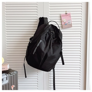 Detail of black outdoor backpack featuring durable fabric and guanlin outdoor print