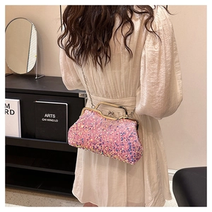 Detailed view of pink sequin evening bag featuring a metal frame and fine chain strap
