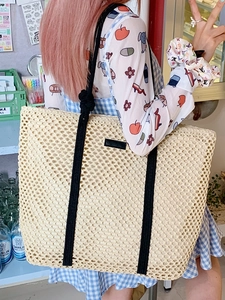 Summer woven tote bag in cream white with black straps for beach travel and commuting