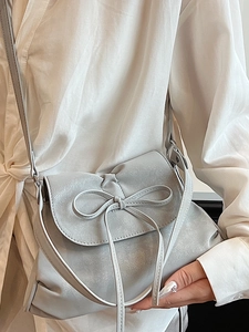 Chic light gray ballet-style bow underarm bag with pearlescent faux leather finish