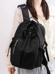 Minimalist black outdoor backpack for students with durable nylon fabric and buckle detail