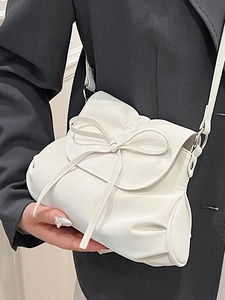 White ballet style bow shoulder bag with pleated details and elegant crossbody strap