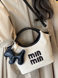 Minimalist straw basket bag with leather trim and embroidered min min logo for summer