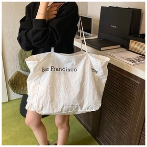 Close-up of a white eco-friendly tote bag with San Francisco text and crinkle texture