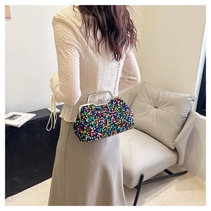 Detail of colorful sequined evening bag with silver metal clasp and chain strap