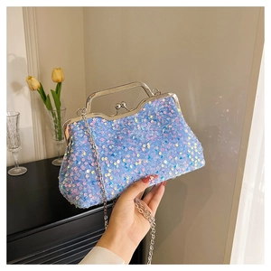 Close-up of sparkling light blue sequin evening bag with silver heart-shaped lock and chain