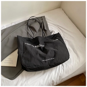 Close-up of black recycled nylon tote bag with San Francisco print and minimal shoulder strap