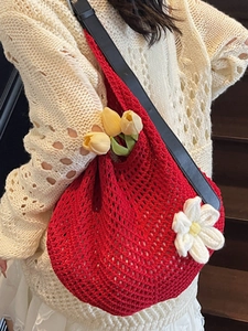 Red hollow crochet shoulder bag with white flower detail and black leather strap