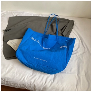 Close-up of royal blue tote bag featuring San Francisco print on soft nylon fabric