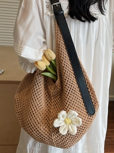 Handmade hollow knit shoulder bag with white flower decoration and adjustable leather strap