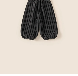 Detailed view of grey striped fleece-lined kids pants with elastic ribbed ankle cuffs