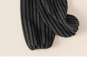 Detail view of thickened grey striped fleece joggers showing the elastic ribbed ankle cuffs