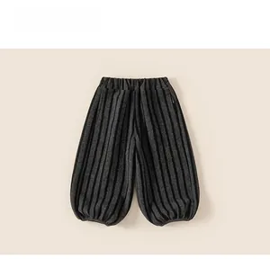 Close-up of vertical striped fabric texture and elastic waistband on thick winter kids pants