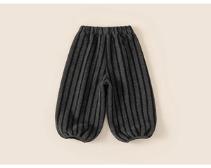 Close-up of black and grey striped knit kids jogger pants with elastic ankle cuffs