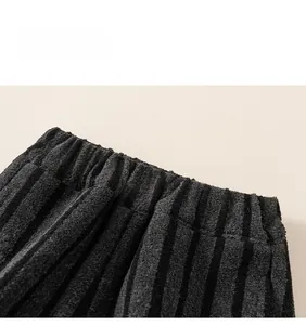 Detail of thickened fleece lining and wide elastic waistband on kids striped pants