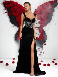 Detailed shot of black velvet dress with colorful rhinestones and high side slit