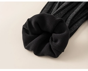 Detail view of thick black fleece lining and striped knit fabric on winter thermal pants