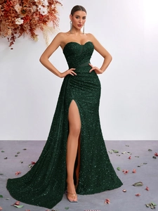 Detail of dark green sequined evening gown with heart neckline and thigh-high split
