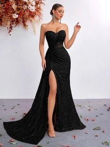 Detailed view of black sequin evening gown with sheer mesh bust and high thigh slit design