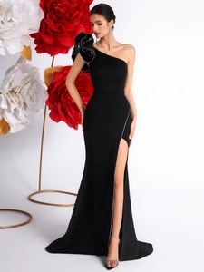 Close-up of elegant black one-shoulder evening gown with layered 3D floral accents