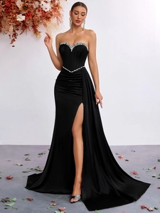 Detail of silver rhinestones on a black strapless satin dress with high side slit