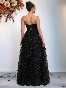 Elegant black strapless evening gown with 3D floral petals and tiered tulle skirt