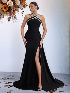 Elegant black halter evening gown with rhinestone trim and a high leg slit for parties