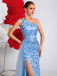Detail of beaded sky blue sequins and high slit on a one-shoulder evening gown