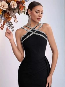 Elegant black halter evening gown with rhinestone neckline and side slit fishtail design