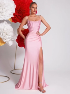 Detail of pink satin evening dress with sequin embroidery and high slit hemline