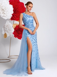 Detail of light blue sequined evening gown featuring elegant side tulle drape and high slit