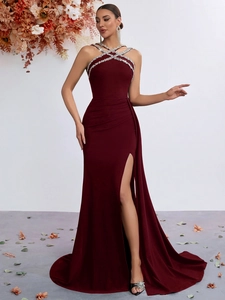 Detail of burgundy evening gown showing rhinestone halter neckline and velvet texture