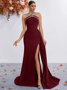 Detail of cross halter neck with rhinestones on a burgundy slim fit evening gown