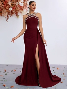 Detail of burgundy fishtail evening gown with halter neck and sparkling rhinestones