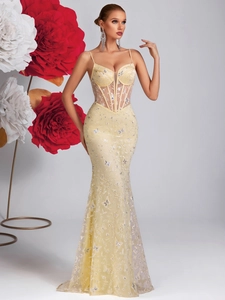 Detail of sheer yellow evening gown with butterfly embroidery and corset boning