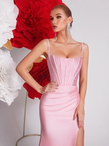 Close-up of pink fishbone corset dress with glittering rhinestones and side slit detail