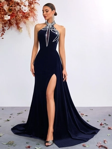 Detailed close-up of dark blue velvet evening dress with halter neck and silver rhinestones