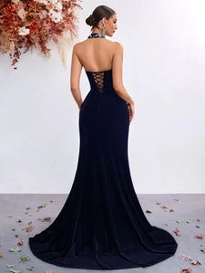Detail view of the elegant open back crisscross lace-up design on velvet evening gown