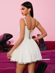 French style white lace party dress with open back lacing on a pink background