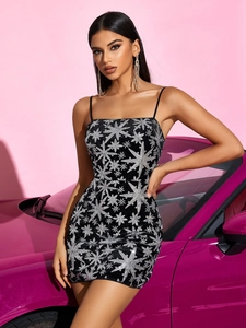Close-up of black sequin bodycon dress with silver star pattern for party wear