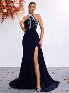 Detail of navy velvet evening dress showing neck rhinestones and high slit texture